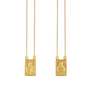 18-karat yellow gold scapular necklace with detailed religious engravings on rectangular pendants, weighing 6.40 grams. A timeless and meaningful symbol of faith.